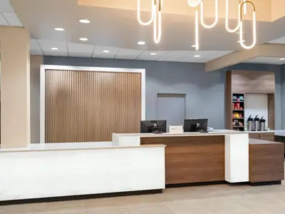 a lobby with a reception desk with a chandelier at Holiday Inn Portsmouth Downtown by IHG in Portsmouth