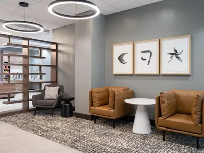 a waiting room with two chairs and a table at Holiday Inn Portsmouth Downtown by IHG in Portsmouth