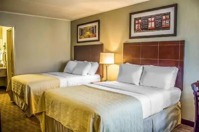 a hotel room with two beds in a room at Quality Inn Cambridge in Cambridge