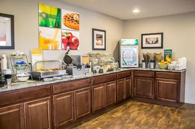a restaurant with a counter with food on it at Quality Inn Cambridge in Cambridge
