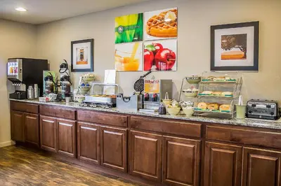 a restaurant with a counter with food on it at Quality Inn Cambridge in Cambridge