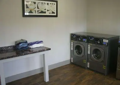 a laundry room with two washing machines and a counter at Quality Inn Cambridge in Cambridge