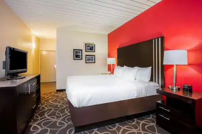 a hotel room with a bed and a flat screen tv at La Quinta by Wyndham Elkview - Charleston NE in Elkview