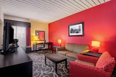 a living room with a couch and a tv at La Quinta by Wyndham Elkview - Charleston NE in Elkview