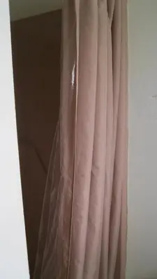 a pink curtain in a room with a window at The Ohio Motel in Bath