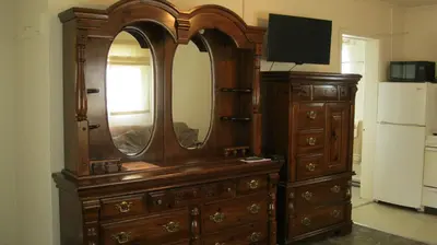a wooden dresser with a mirror on top of it at The Ohio Motel in Bath