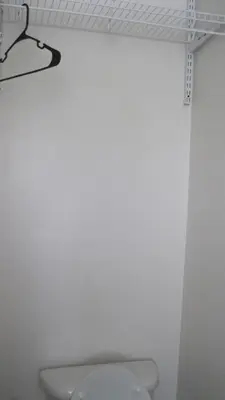 a white bathroom with a toilet and a shelf at The Ohio Motel in Bath