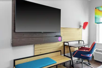 a room with a large flat screen tv on a wall at Tru By Hilton Cleveland Midtown in Cleveland