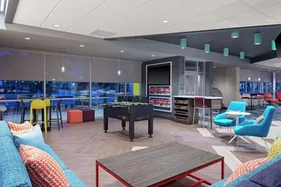 a room with a ping pong table and chairs at Tru By Hilton Cleveland Midtown in Cleveland