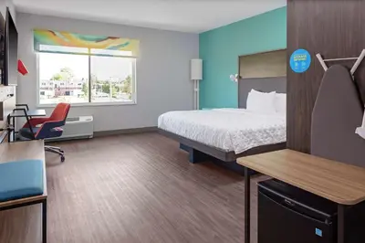 a hotel room with a bed and a desk and a chair at Tru By Hilton Cleveland Midtown in Cleveland