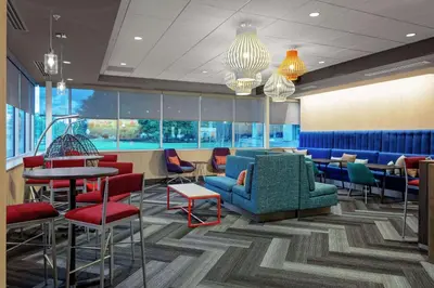 a lobby with chairs and tables and a waiting room at Tru By Hilton Cleveland Midtown in Cleveland