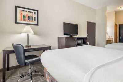 a hotel room with a bed and a desk and a tv at Best Western Mason Inn in Mason