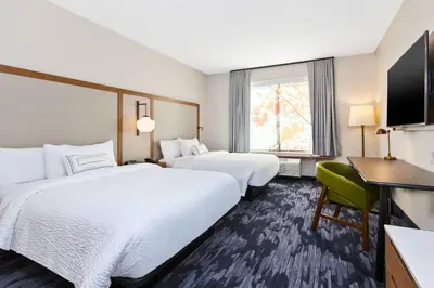 a hotel room with two beds and a desk at Fairfield Inn & Suites by Marriott Cincinnati Airport South/Florence in Florence