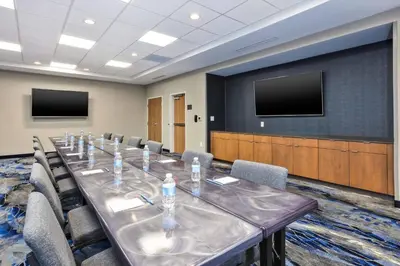 a conference room with a long table and chairs at Fairfield Inn & Suites by Marriott Cincinnati Airport South/Florence in Florence