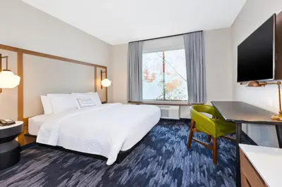 a hotel room with a bed and a desk and a window at Fairfield Inn & Suites by Marriott Cincinnati Airport South/Florence in Florence