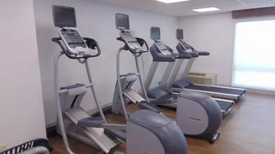 a gym with cardio equipment in a room at Holiday Inn Express & Suites Wapakoneta by IHG in Wapakoneta