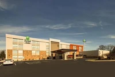 a building with a car parked in a parking lot at Holiday Inn Express & Suites Wapakoneta by IHG in Wapakoneta