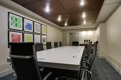 a conference room with a large white table and chairs at Holiday Inn Express & Suites Wapakoneta by IHG in Wapakoneta