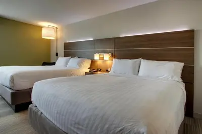 two beds in a hotel room with white sheets at Holiday Inn Express & Suites Wapakoneta by IHG in Wapakoneta