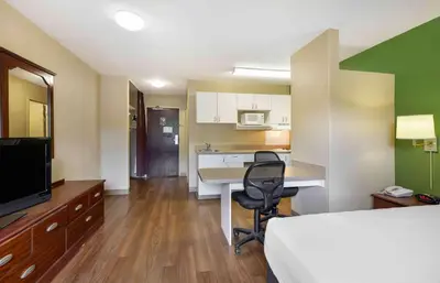 a room with a bed and a desk with a computer at Extended Stay America Suites - Akron - Copley - East in Copley