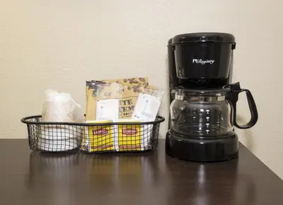 a coffee maker and a basket on a table at Red Roof Inn Columbus Northeast Westerville in Westerville