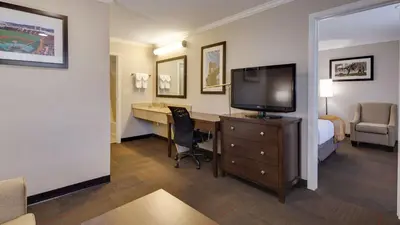 a hotel room with a bed and a desk with a television at Best Western Clermont in Cincinnati