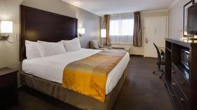 a hotel room with a large bed and a television at Best Western Clermont in Cincinnati