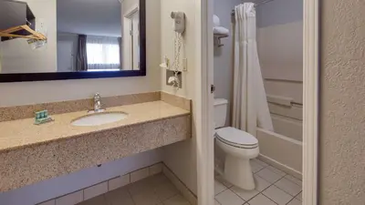 a bathroom with a sink and a toilet and a mirror at Best Western Clermont in Cincinnati