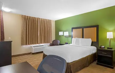 a hotel room with a large bed and a desk at Extended Stay America Select Suites - Columbus - Worthington in Worthington