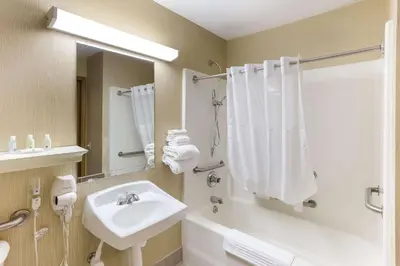 a bathroom with a sink and a bath tub with a sink at Quality Inn Athens in Athens