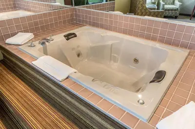 a large white bath tub in a bathroom at Quality Inn Athens in Athens