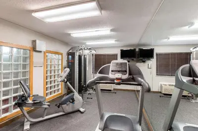 a gym with two exercise bikes and a treadmill at Quality Inn Athens in Athens