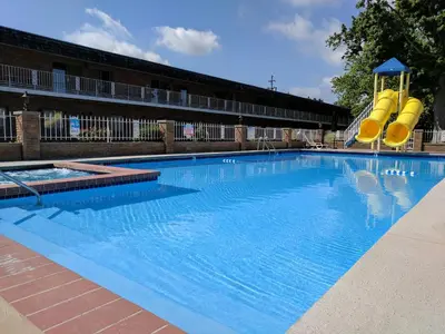 a large swimming pool with a slide in a building at South Shore Inn in Sandusky