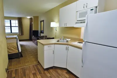 a kitchen with a white refrigerator and a room at Extended Stay America Suites - Cincinnati - Florence - Turfway Rd in Florence