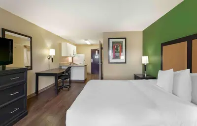 a hotel room with a large bed and a desk at Extended Stay America Suites - Cleveland - Brooklyn in Brooklyn