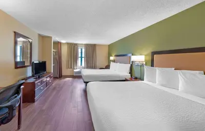 a hotel room with two beds and a flat screen tv at Extended Stay America Suites - Columbus - Dublin in Dublin
