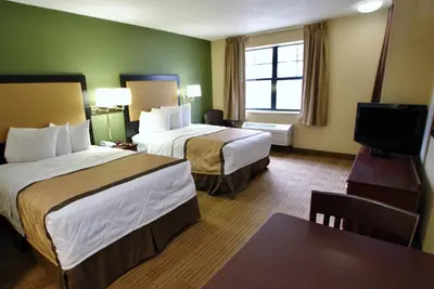 a hotel room with two beds and a flat screen tv at Extended Stay America Suites - Columbus - Dublin in Dublin