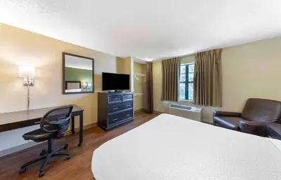 a hotel room with a bed and a desk and chair at Extended Stay America Suites - Columbus - Dublin in Dublin