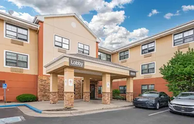 a luxury hotel with cars parked in a parking lot at Extended Stay America Suites - Dayton - North in Dayton