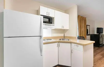 a white kitchen with a refrigerator and a sink at Extended Stay America Suites - Dayton - North in Dayton