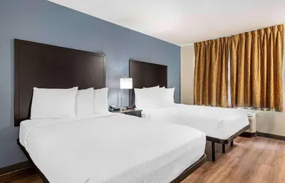 a hotel room with two beds and a window at Extended Stay America Suites - Dayton - North in Dayton