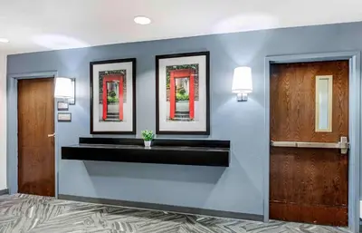 a lobby with two mirrors on a wall with a sink at Extended Stay America Suites - Dayton - North in Dayton