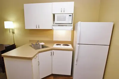 a kitchen with a white refrigerator and a sink at Extended Stay America Suites - Cincinnati - Covington in Covington
