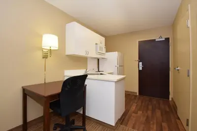 a small kitchen with a desk and a refrigerator at Extended Stay America Suites - Cincinnati - Covington in Covington