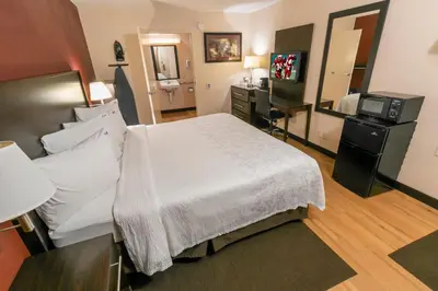 a hotel room with a bed and a desk at Red Roof Inn PLUS+ Columbus - Dublin in Dublin