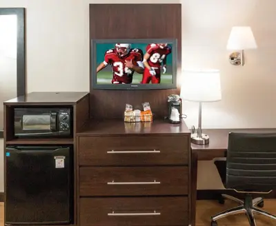 a hotel room with a desk with a tv and a football at Red Roof Inn PLUS+ Columbus - Dublin in Dublin