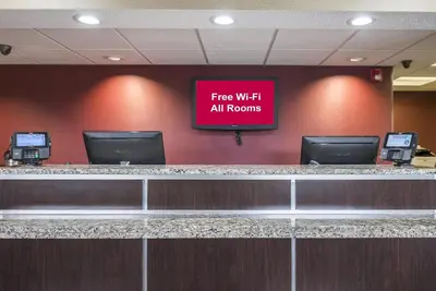 a sign that says free wifi all rooms in an airport at Red Roof Inn Toledo - Maumee in Maumee