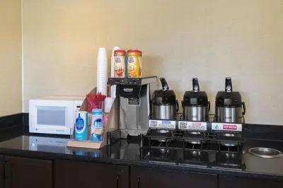 a kitchen counter with a coffee maker and a microwave at Red Roof Inn Cincinnati - Sharonville in Sharonville