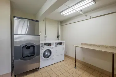 a laundry room with a washing machine and a washer at Red Roof Inn Cincinnati - Sharonville in Sharonville