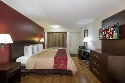a hotel room with a bed and a desk at Red Roof Inn Columbus East- Reynoldsburg in Brice